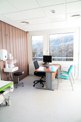 Office with medical bed and scenic view through large window