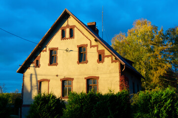 Fototapeta na wymiar Former orphan boys' home. History of building dates back to 1892, side view, sunset. Ledziny, Poland.