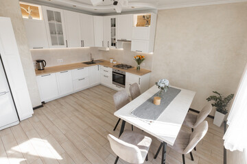 a modern white kitchen interior with wooden worktop