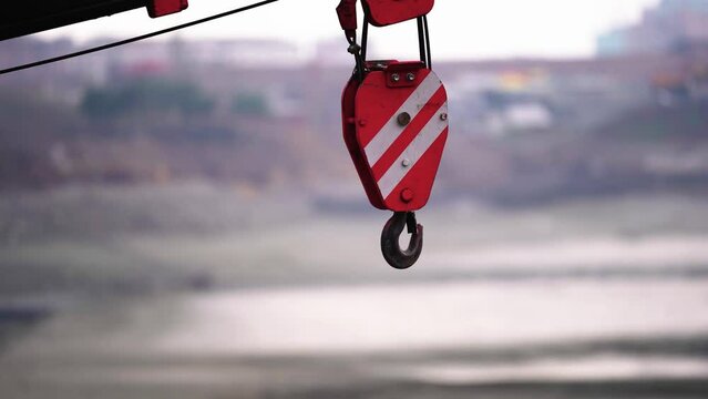  Construction metallic crane hook at work. Crane movement. Industrial concept. Construction works.