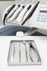 Different dental instruments and tools in a dentists office, Close up detail of dentist work tools. Set of metal medical equipment tools for teeth dental care