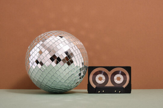 Shiny disco ball and audio cassette. Disco and fun party.