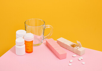 Capsules, medicine pills and glass cup. Health care.