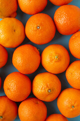 Many fresh oranges top view. Vibrant vertical photo of citrus fruits flat lay background. Vitamin C