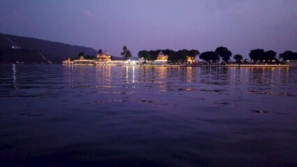 Udaipur, Rajasthan, India-October 30 2023; A Dramatic view of the Jag Mandir lake palace in the golden hours, a popular Wedding and travel destinations in Rajasthan, India.

