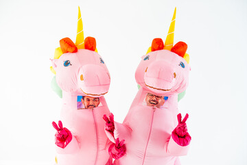 Pink unicorn inflatable costumes with V sign - obrazy, fototapety, plakaty