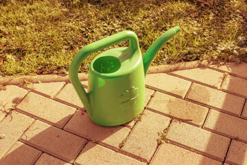 Watering can on the garden pathway.Spring season
