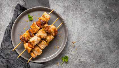 Chicken skewers. top view shot of Chicken kebab skewers on grey plate, copy space