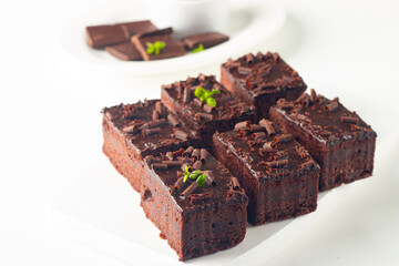 Delicious chocolate brownies with mint on white background. Sweet cake concept. 