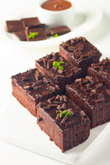 Delicious chocolate brownies with mint on white background. Sweet cake concept. 