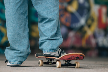 close-up of feet of a young man with skateboard on the street