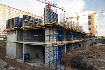 Stages of construction of a residential building, construction stage from the foundation pit to the...