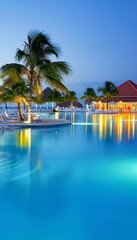 Night view of a tropical resort pool amidst lush greenery, exuding elegance and a serene atmosphere.