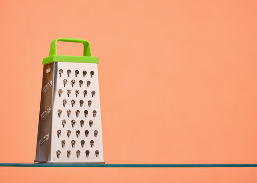 Metal grater for cheese or vegetables. Copy space for text.