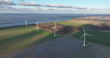 Sustainable energy generation at wind turbine farm. Power and electricity from the wind in a sustainable manner. Clean air and measures agaianst climate change.
