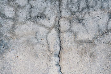 Crack in cracked concrete wall background
