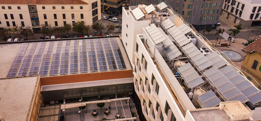 Solar Panel Roof Multifamily Apartment Building on Cityscape Backgroung. Modern High rise House...