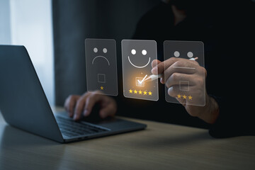 Customer Satisfaction Rating with Digital Interface. Businessman use laptop and digital pen selecting a glowing five-star rating on a virtual interface with smile emotion emoticon feedback options.