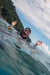 A funny girl scuba diving wearing googles in Brazil - ilha grande