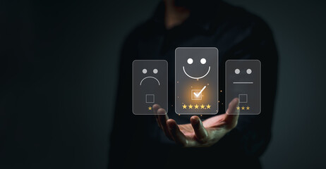 Customer Satisfaction Rating with Digital Interface. Businessman standing and holding selecting a glowing five-star rating on a virtual interface with smile emotion emoticon feedback options.
