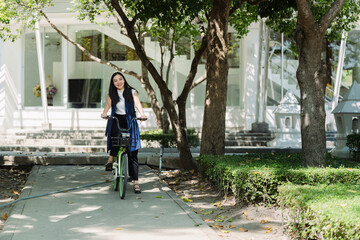 Professional Business woman with bike in the morning walking in the street to work. Eco friendly