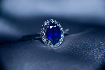 Golden ring with blue gemstone, sapphire