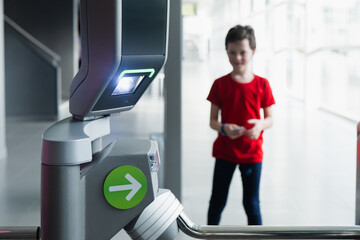 Boy using ticket machine at museum entrance