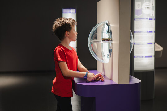Boy exploring interactive exhibit at science museum