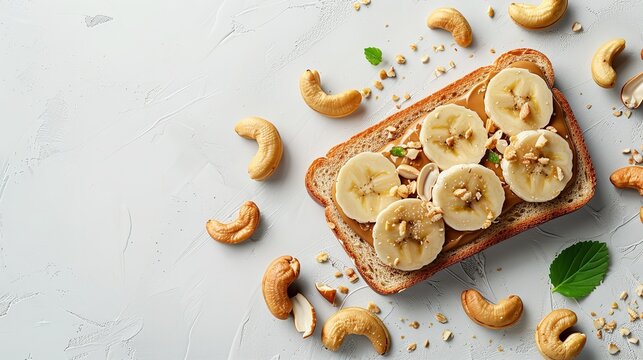 On a white table, toast with cashews, banana slices, and nut butter with top view and space for text, Generative AI.