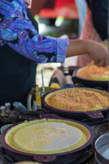 Apam balik is a Southeast Asian fluffy pancake with cream corn and peanuts. This soft pancake is usually made to order on street market.