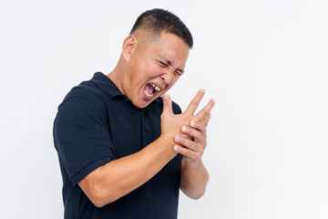 A middle-aged man grimaces in pain, clutching his hand, demonstrating symptoms of painful arthritis in his knuckles.