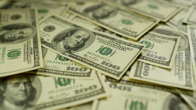 There is a large amount of cash in dollars on the table. These banknotes indicate financial stability and potential for investment. High quality 4k footage