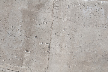 gray smooth concrete surface with small depressions, streaks and seams
