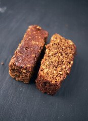 A  beautiful chocolate flapjack dessert slice, served on a rustic slate plate board. Gourmet and posh trendy cafe and bakery treat. Sugar sweeties.