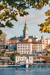 Serene river views complement Belgrade's architectural charm, with churches adorning the skyline under sunny skies.