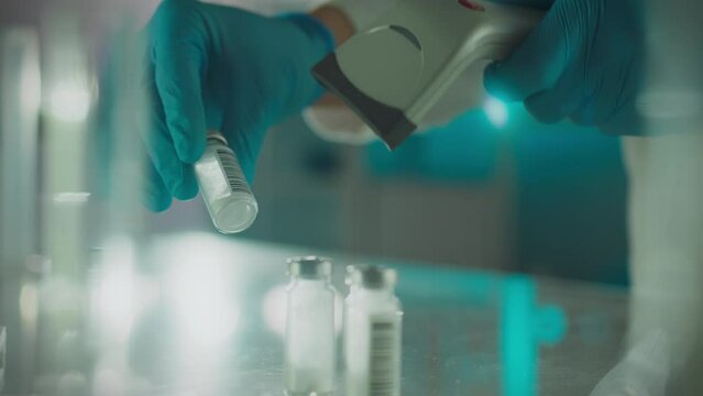 A scientific researcher wearing nitrile gloves carefully applies modern accounting in modern laboratory. Camera movement young expert holding scanner in his hand is developing cure for the flu, doctor