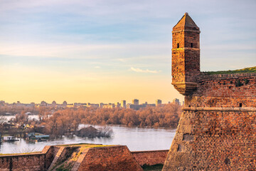 golden hues of sunset atop Belgrade's Kalemegdan fortress, where visitors are greeted by historic...