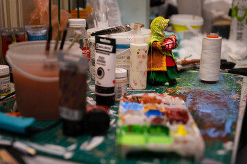 The Artist's Colorful Workspace: A Table Laden with Paints, Creating a Working Atmosphere