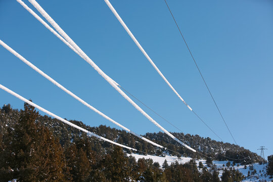 Electrical wires of power line covered by snow