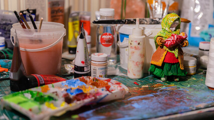 The Artist's Colorful Workspace: A Table Laden with Paints, Creating a Working Atmosphere