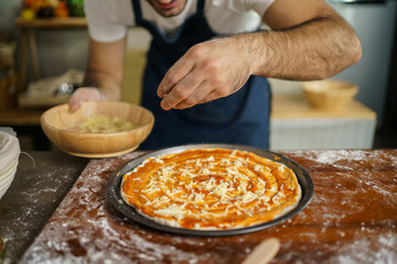 Man making a pizza.
