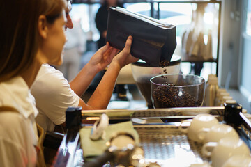 Baristas working in coffee shop.