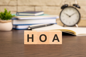 the wooden blocks forming the word HOA - Homeowner Association concept