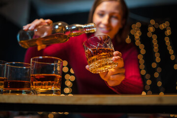 Barwoman pouring whiskey whiskey glass..