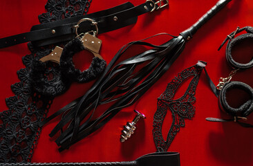 Set of toys for adults: handcuffs, mask, whip. The view from the top