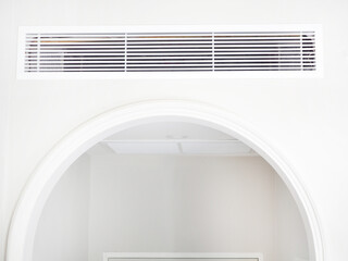 Air conditioning wall mounted ventilation system on ceiling in the white hotel or resort room....