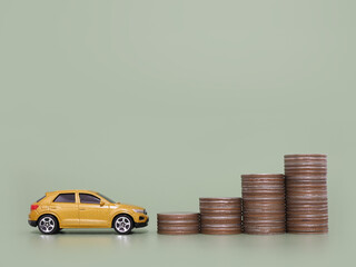 Toy car and stack of coins. The concept of saving money and manage to success transport business