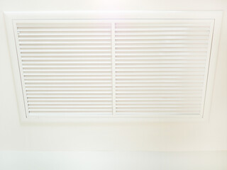 Modern ceiling mounted cassette type air conditioning system in hotel room. Closeup photo, blurred.