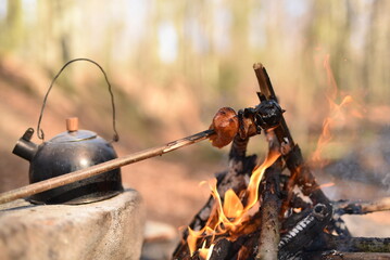 Roasting pepperoni in the forest