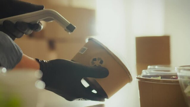 Ecologically pure. Concentrated scanning with a laser beam in the finished product warehouse. Mobile kitchen cook uses handheld scanner for item, recycling and recycling trend, cardboard